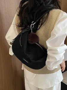Schwarze Vintage-Halbmondtasche mit Plüschbommel für den minimalistischen Alltag