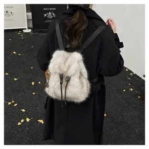 Geräumiger weißer Kunstpelz-Rucksack für Damen im Preppy-Stil über einem schwarzen Mantel