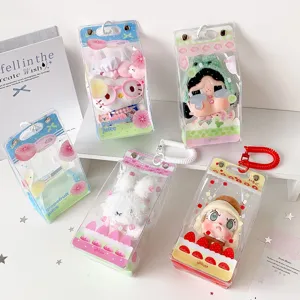 Detail showing multiple PVC storage bags for plush dolls with colorful fruit and cake patterns