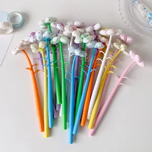 Close-up of colorful gel pens with fabric flower tops arranged in a fan shape.