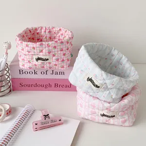 Detailed view of cute quilted fabric storage baskets with strawberry and floral patterns
