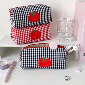 Detailed macro view of cute plaid pencil pouch with tomato embroidery and Hisocute tag