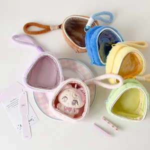 Close-up of colorful plush doll display bags with transparent windows for anime dolls.
