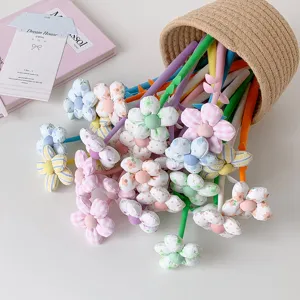 Macro view of colorful fabric flower toppers and textures on cute novelty gift gel pens