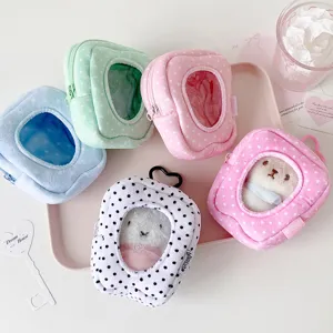 Detail of tooth-shaped plush doll display bags in various pastel colors and patterns