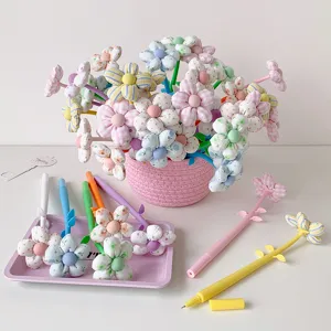 Detailed shot of cute fabric flower pens in various colorful patterns and designs.