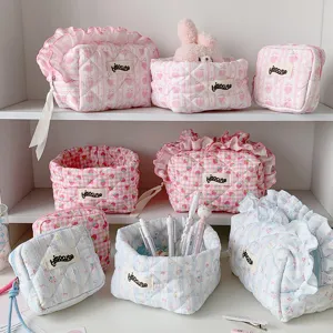 Various quilted fabric storage baskets and pouches with cute strawberry and heart patterns