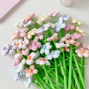 Detailed cluster of colorful pens featuring soft fabric flower toppers in various patterns