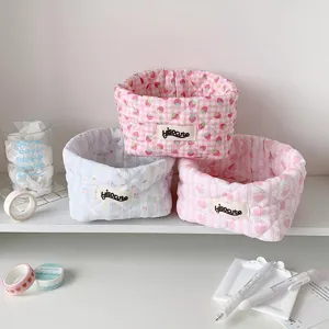 Quilted fabric storage baskets in cute strawberry and heart patterns for desktop