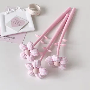 Close-up of three pink fabric flower gel pens featuring soft plush flower tops and stems.
