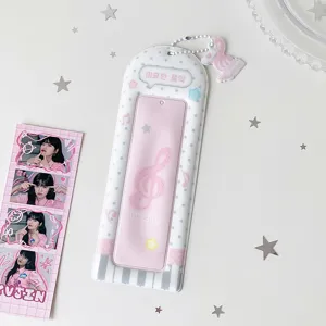 Cute pink PVC four-cut photo card holder with musical note design and charm pendant