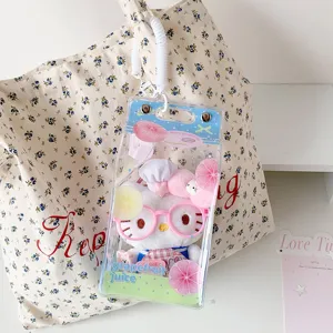 Detail view of a PVC doll display bag with grapefruit print hanging on a floral tote bag