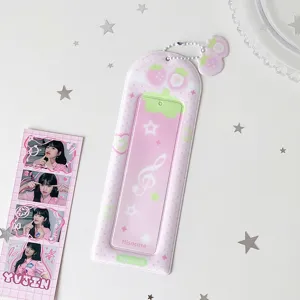 Detail view of a pink strawberry PVC photocard holder with cute star decorations.