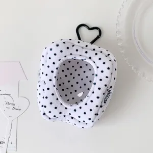 Close-up of polka dot plush doll display bag with clear window and heart carabiner