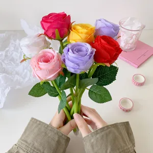 Close-up of a bouquet of colorful artificial rose ballpoint pens held in hands