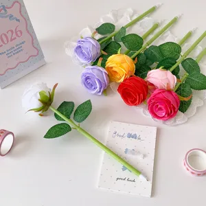 Detailed macro view of vibrant artificial rose ballpoint pens for desktop decoration