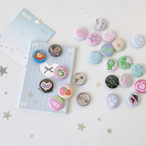 Detailed view of variety of 25mm cute cartoon mini badges with colorful patterns
