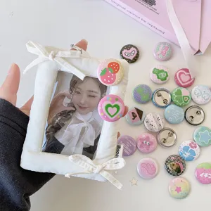 Detailed close-up showing cute 25mm cartoon badges and a white plush photo frame for DIY decoration