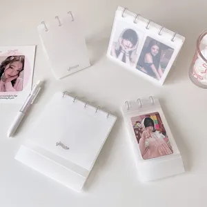 Minimalist translucent PP desktop photo album displaying various K-pop idol photocards.