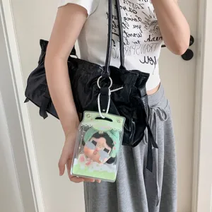 Clear PVC milk box shape display bag for plush dolls hanging on a black leather handbag