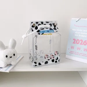 Close-up view of a clear PVC milk carton storage bag with black cow print for plush doll display