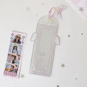 Detailed macro view of a clear glittery card holder featuring angel wings and pink chain