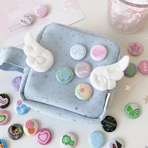 Detailed view of variety of 25mm mini cute cartoon badges on light blue corduroy bag