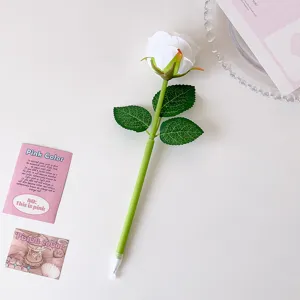 Detailed view of an artificial white rose ballpoint pen with green leaves on a white background