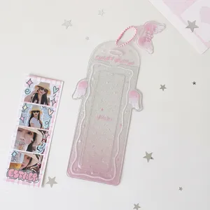 Detail view of a glittery angel wing photocard holder designed for four-cut photo storage