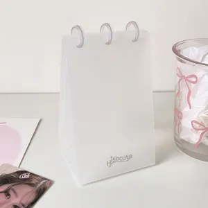 Detailed close-up of a minimalist transparent PP desk photo album for photocards.