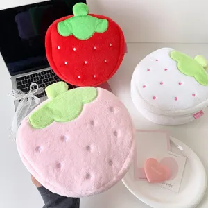 Detailed view of cute plush strawberry-shaped makeup bags in red, pink and white colors