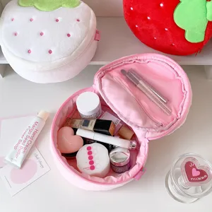 Inside view of a plush strawberry makeup bag with cosmetic storage