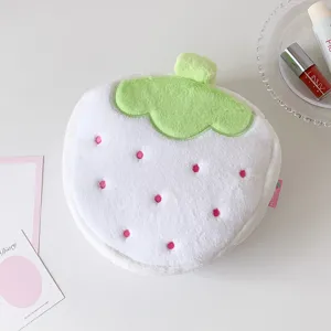 Soft plush strawberry makeup bag with cute pink embroidered dots and green leaf detail