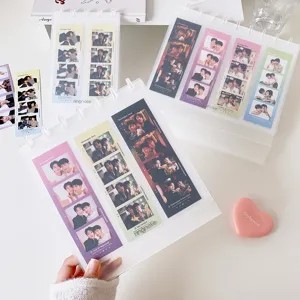 Close-up of a transparent mushroom ring photocard binder with four-cut photo strips.