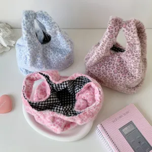Detailed view of plush leopard print handbags with black and white checkered lining