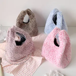 Four plush leopard print handbags displayed in pink, blue, brown, and mauve colors