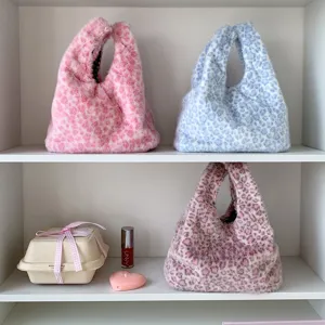 Faux fur leopard print handbags in various colors displayed on a minimalist shelf