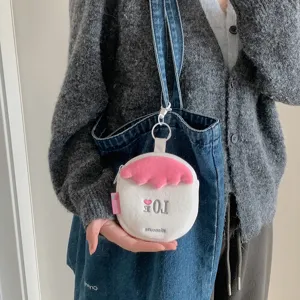 Macro view of cute plush strawberry coin purse used for earphone and card storage