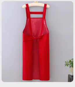 Red waterproof kitchen apron detail view, durable fabric and comfortable cross back straps style.