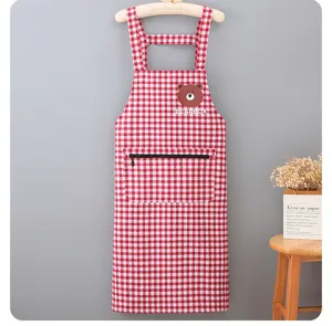 Red and white checkered apron detail showing zippered pocket and cute bear graphic design.
