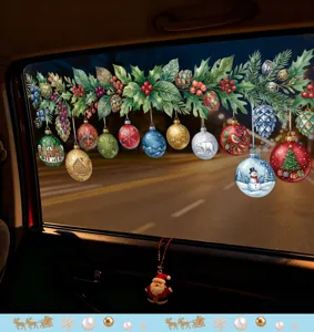 Festive Christmas window stickers with holly and ornamental balls on a car window.