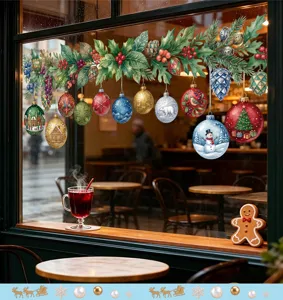 Close-up of festive Christmas window stickers showing red berry garlands and ornaments.