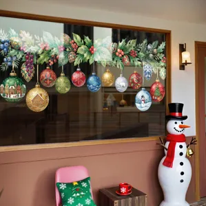 Detailed view of festive Christmas bauble window stickers with holly and red berries decor