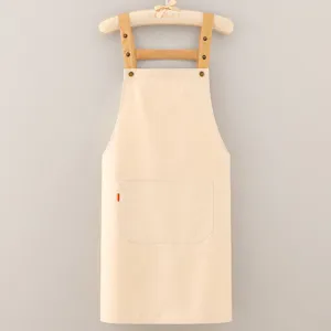 Minimalist beige cotton apron with adjustable brown straps and front pocket for cooking.