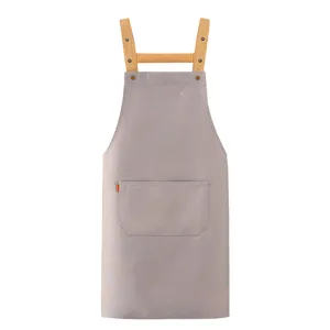 Professional grey cotton twill work apron with brown straps and front pocket for cooking.