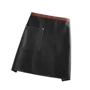 Waterproof PU leather waist apron for kitchen cooking, durable black half apron with tool pocket.