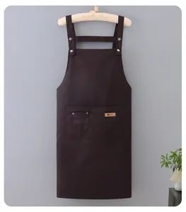 Poly-cotton coffee shop work apron detail view, featuring durable fabric and front pocket design.