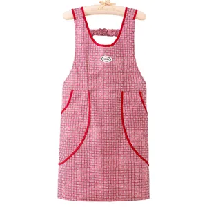 Waterproof kitchen apron with red grid pattern, double pockets, clean hanging display style.