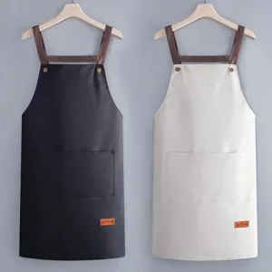 Waterproof kitchen apron with cross straps and pockets, durable PVC work bib for cooking cleaning.