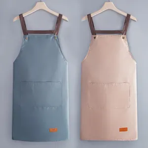 Waterproof kitchen apron with pockets, adjustable straps, durable PVC oil-proof work wear for home cooking.